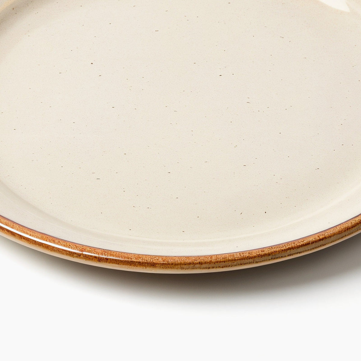 Danmero Sandstone Dessert Plate — macro close-up of the plate's raised rim and glaze pooling