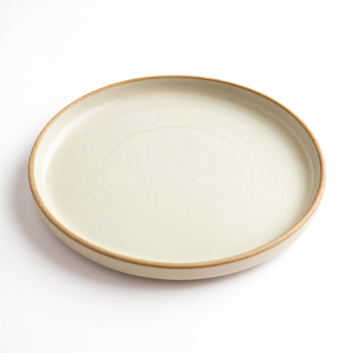 Danmero Eggshell Dinner Plate — three-quarter angled view showing top face, glaze, and raised rim